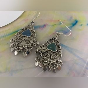 Dangle silver toned and turquoise colored earrings